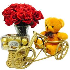 Teddy on rickshaw with chocolate and flower