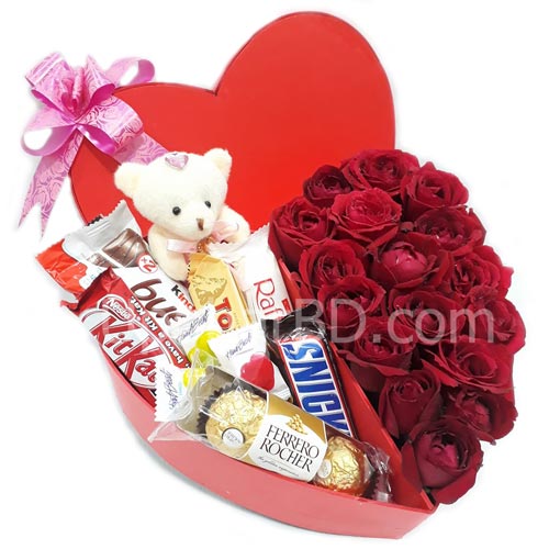Heart shaped gift box with roses and chocolate